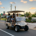 A professional family driving a street-legal golf cart on a quiet suburban road, passing a 30 mph speed limit sign, adhering to public road regulations for safe community travel.