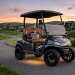 A custom high-performance golf cart with upgraded speed controller and motor driving on a hilly residential road during sunset, showcasing hill-climbing power.