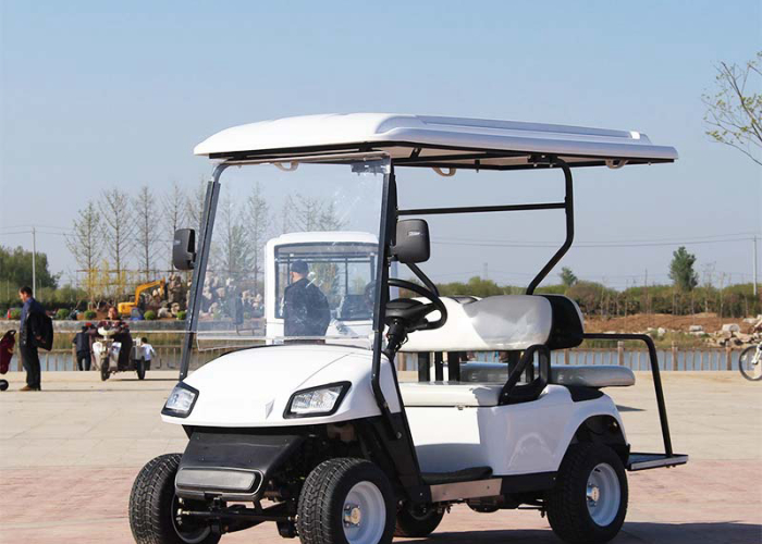 2+2 electric golf cart parked near a charging and boarding area
